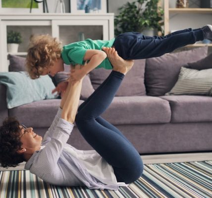 a woman and a child playing on the floor